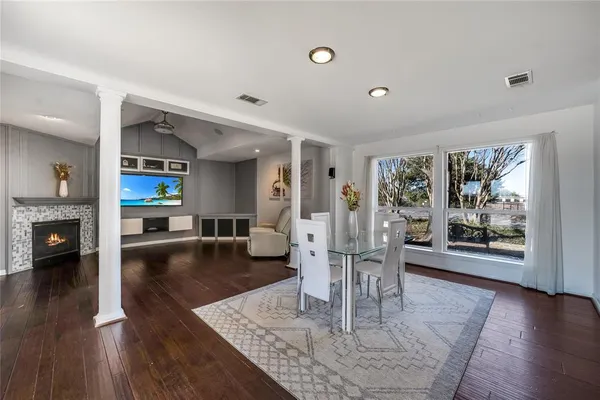 a living room with fireplace furniture and a wooden floor