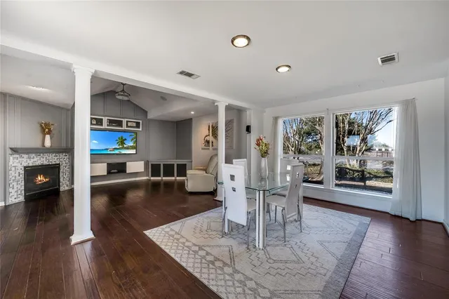 a living room with fireplace furniture and a wooden floor