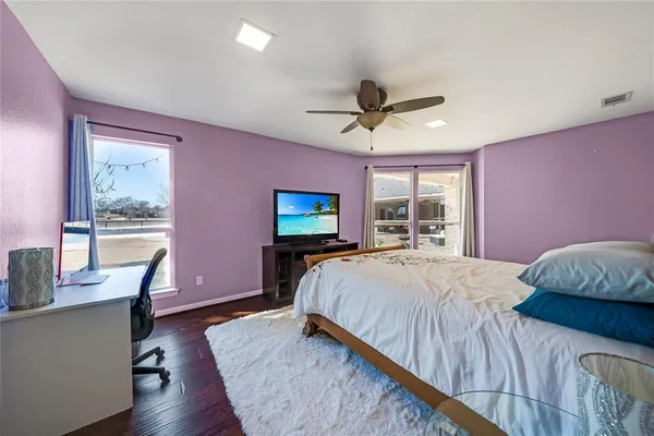 a bedroom with a bed and a desk