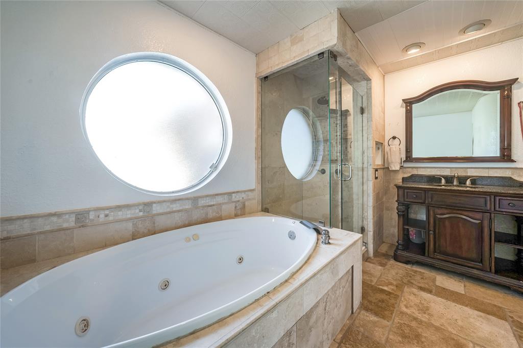 750 Long Road Lucas, TX 75002 - Photo 22 of 39 a bathroom with a bathtub a mirror and a sink