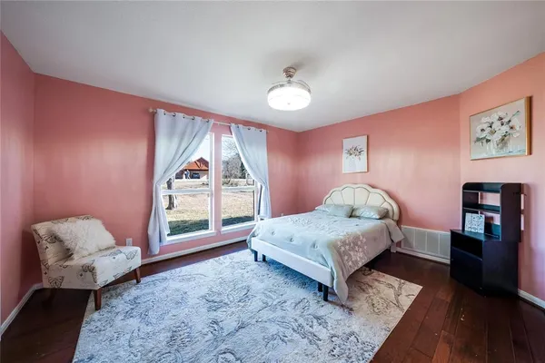 a spacious bedroom with a bed and a large window