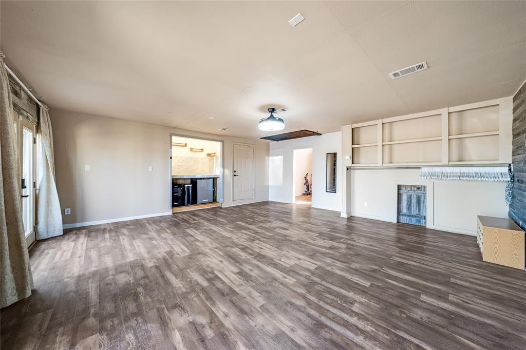 750 Long Road Lucas, TX 75002 - Photo 31 of 39 a view of an empty room with wooden floor and a window