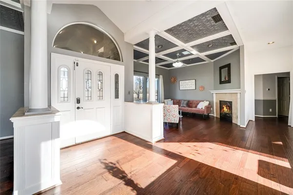 a living room with fireplace furniture and a wooden floor
