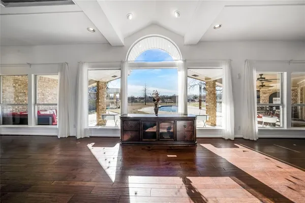 a living room with fireplace furniture and a large window