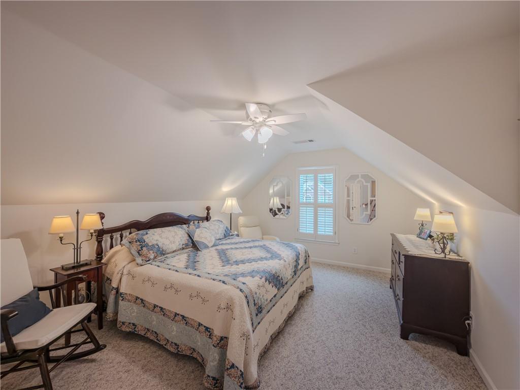 4284 Cedar Bluff Way Southwest Lilburn, GA 30047 - Photo 39 of 62 a spacious bedroom with a bed and a chandelier