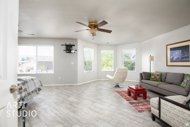 342 South Willow Patch Road Lehi, UT 84043 - Photo 25 of 30 Spacious room featuring wood-finish flooring, multiple windows, and two ceiling fans