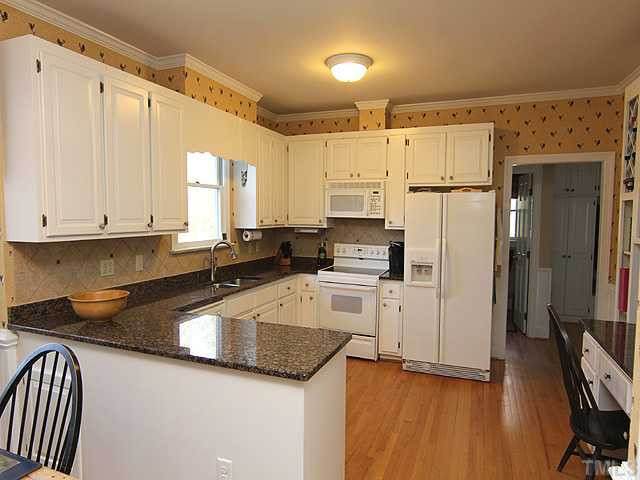 2512 Ashley Court Raleigh, NC 27607 - Photo 5 of 24 Hardwoods continue through kitchen, tile backsplash, crown molding, 9ft. smooth ceilings - wonderful detail at every turn. Kitchen