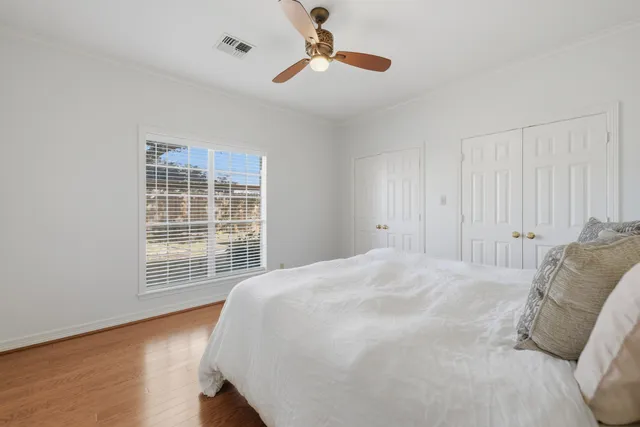 a spacious bedroom with a bed and a chandelier