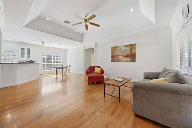 a living room with furniture and a wooden floor