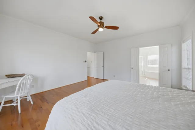 a bedroom with a bed and a chair