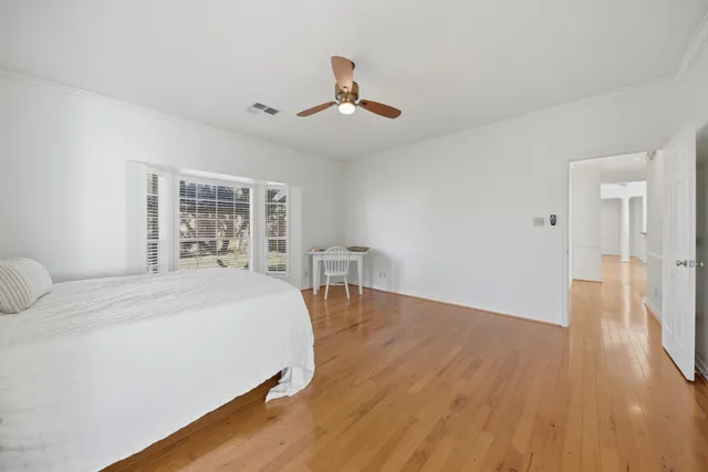 a spacious bedroom with a bed and a table in it