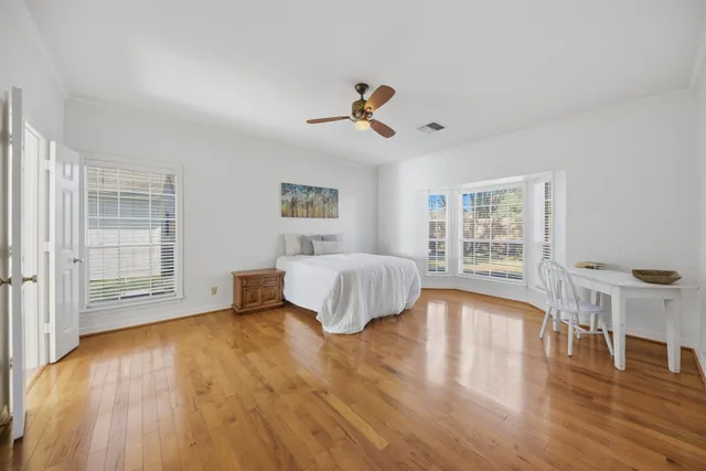 a spacious bedroom with a bed and a table
