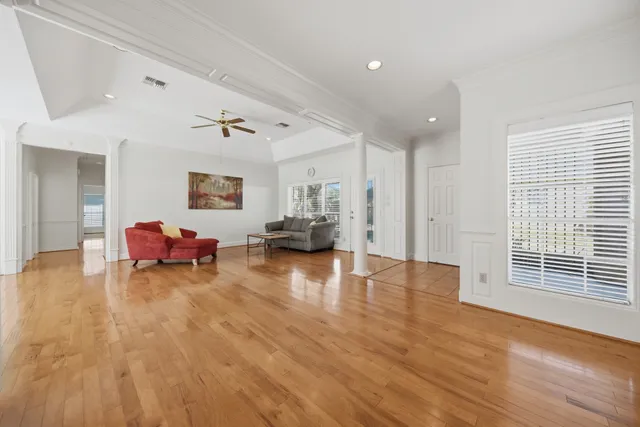 a living room with furniture and a wooden floor