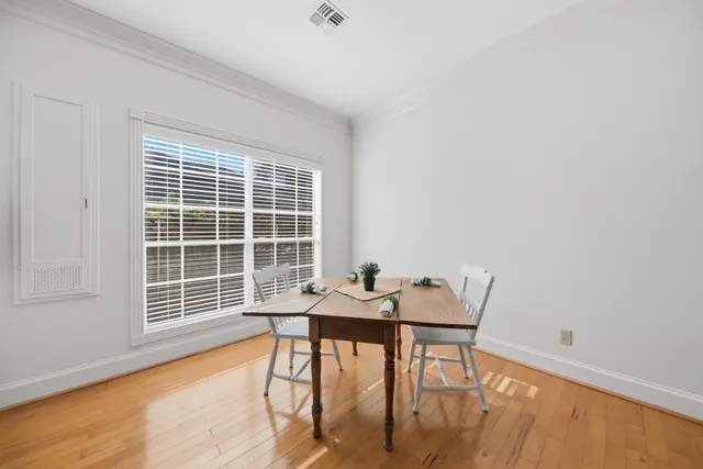 a view of a room with furniture and wooden floor