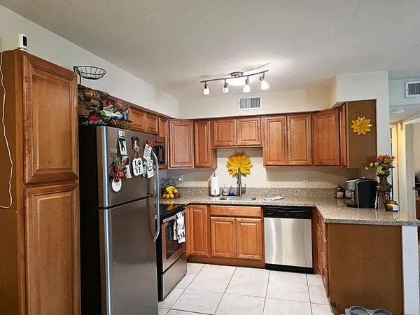 a kitchen with a refrigerator and microwave