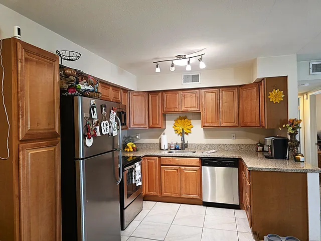 a kitchen with a refrigerator and microwave