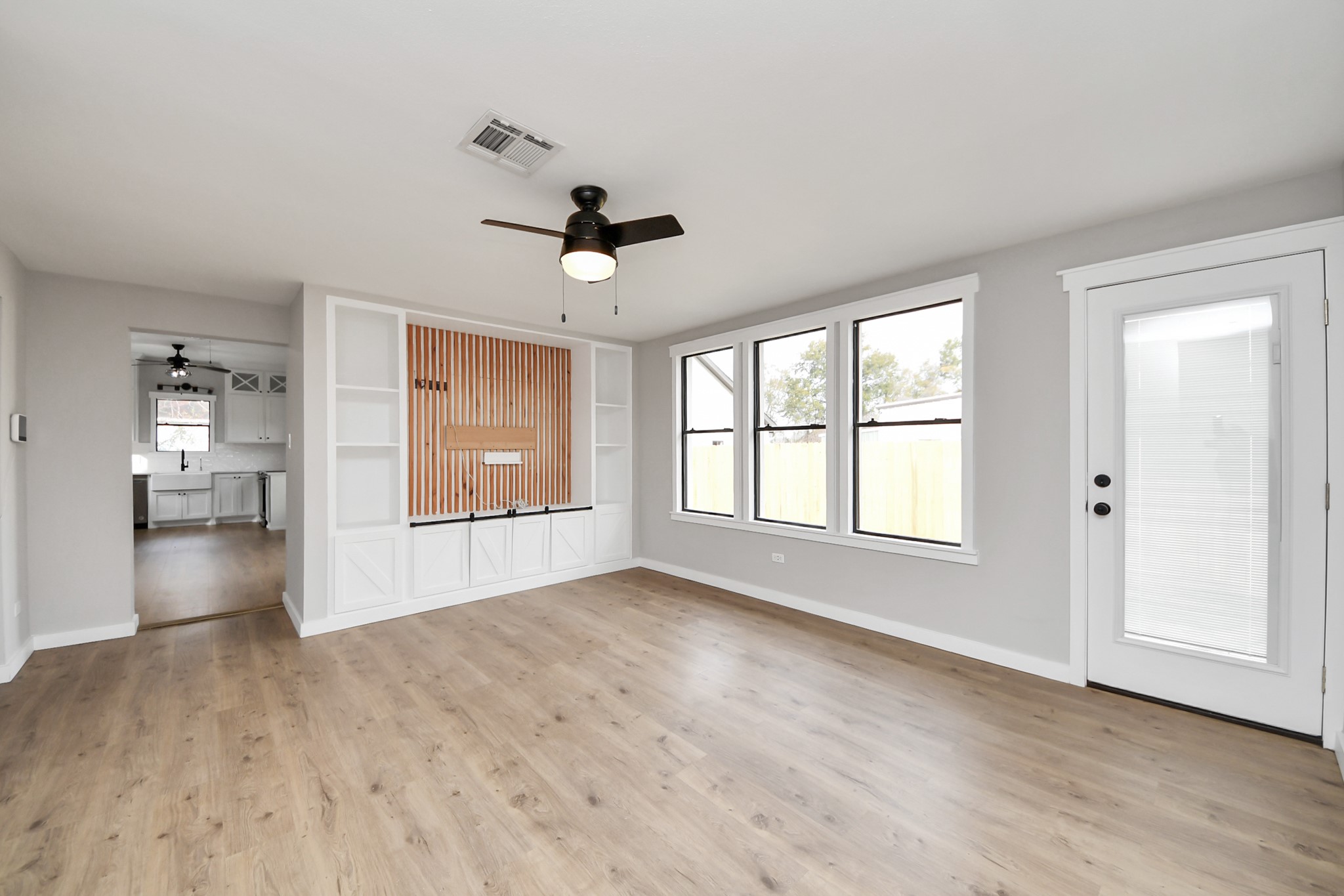 1507 Brooks Avenue Rosenberg, TX 77471 - Photo 14 of 35 a view of an empty room with a window and wooden floor