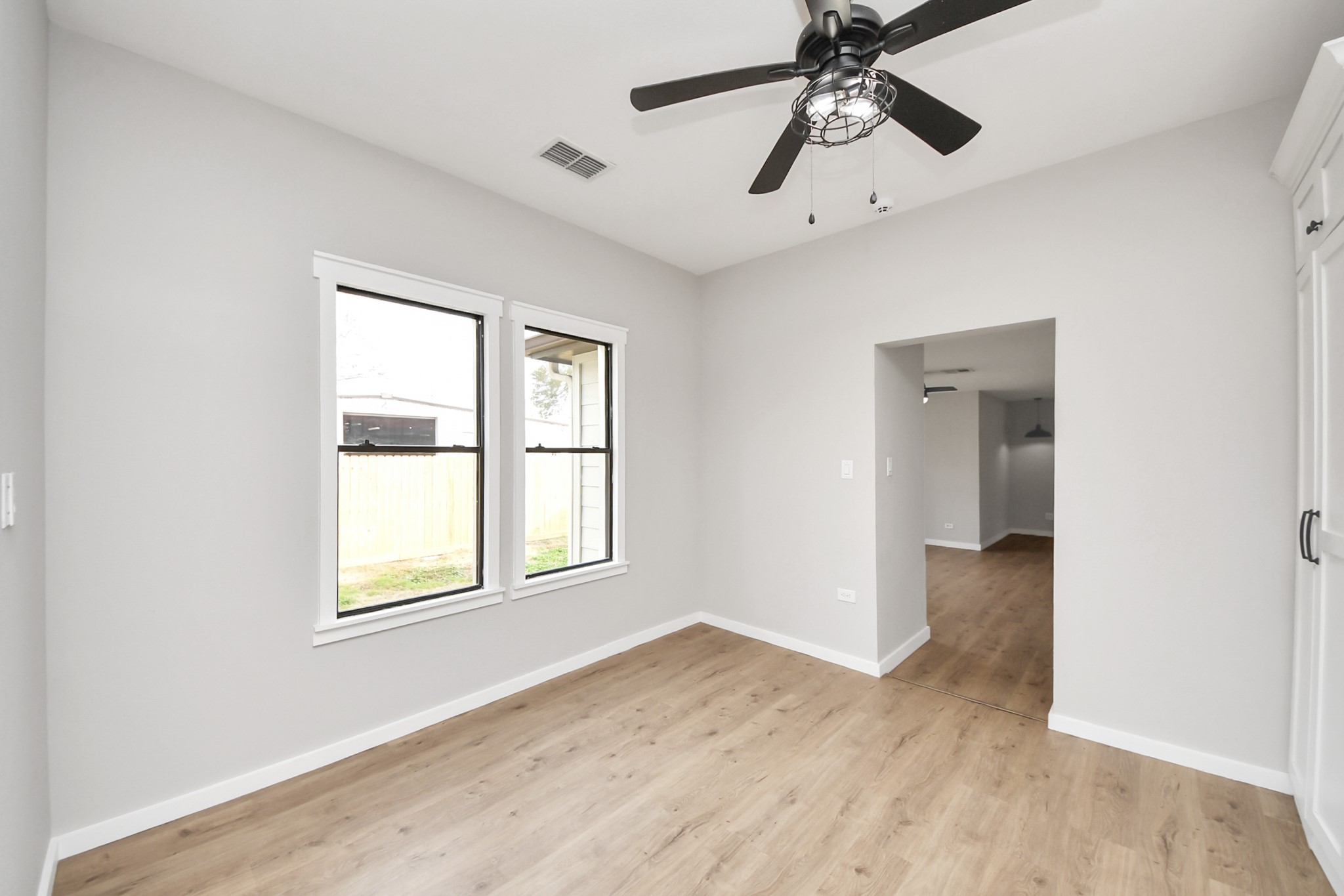 1507 Brooks Avenue Rosenberg, TX 77471 - Photo 26 of 35 a view of an empty room with a window and wooden floor