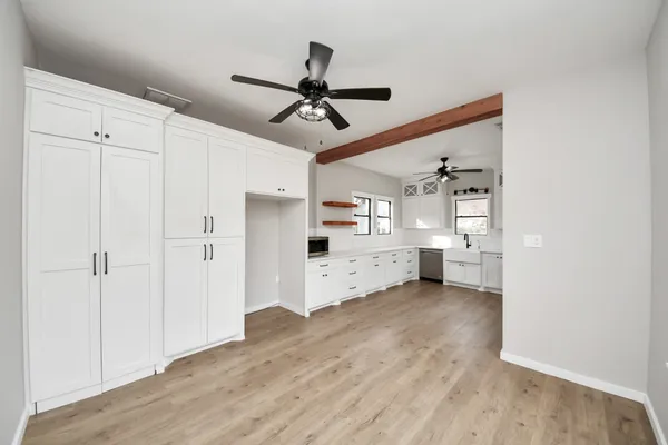 an aerial view of a house with a yard and large tree