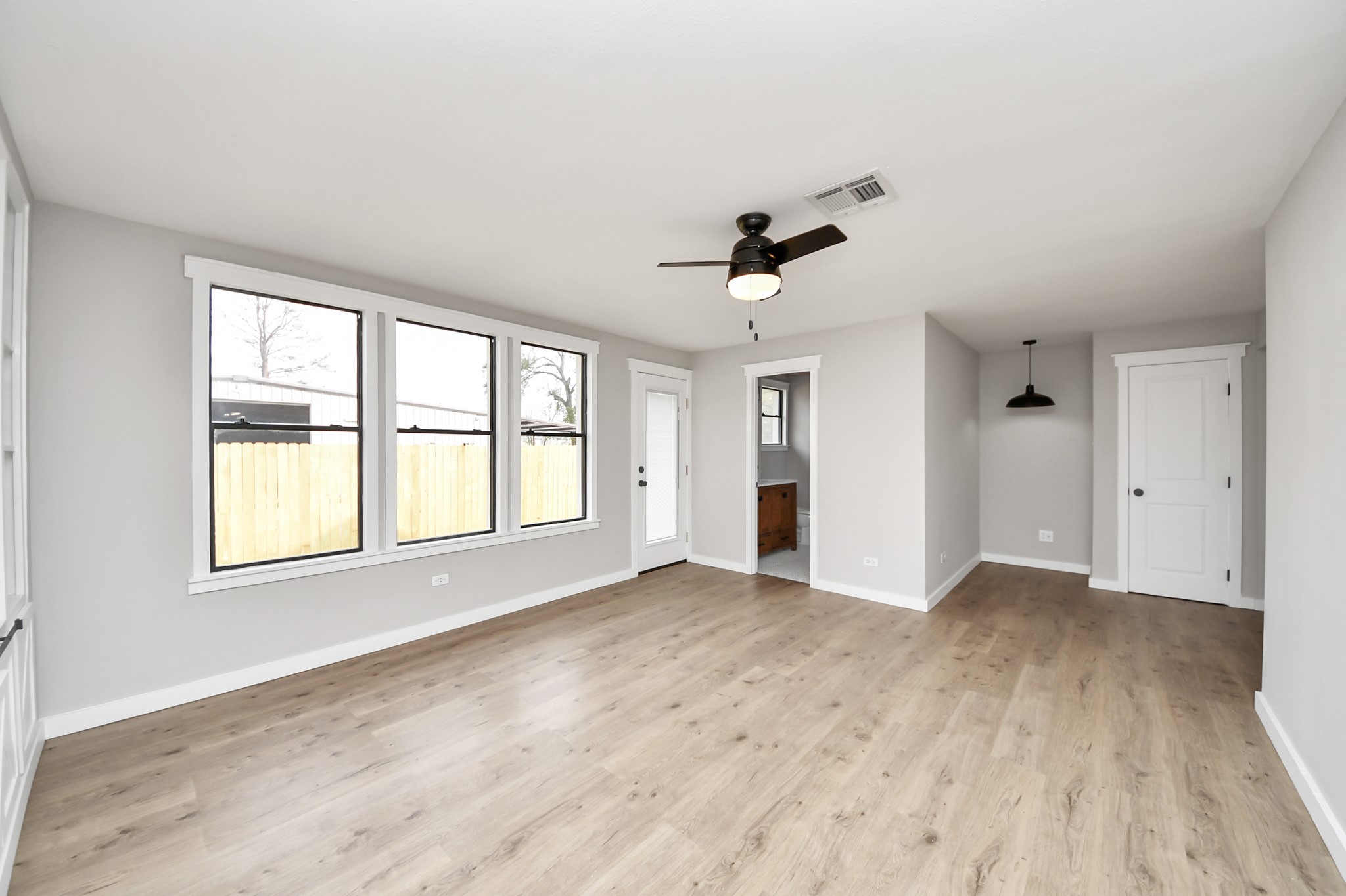1507 Brooks Avenue Rosenberg, TX 77471 - Photo 29 of 35 an empty room with wooden floor and windows