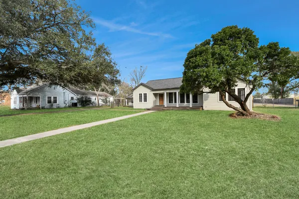 a front view of house with yard and green space
