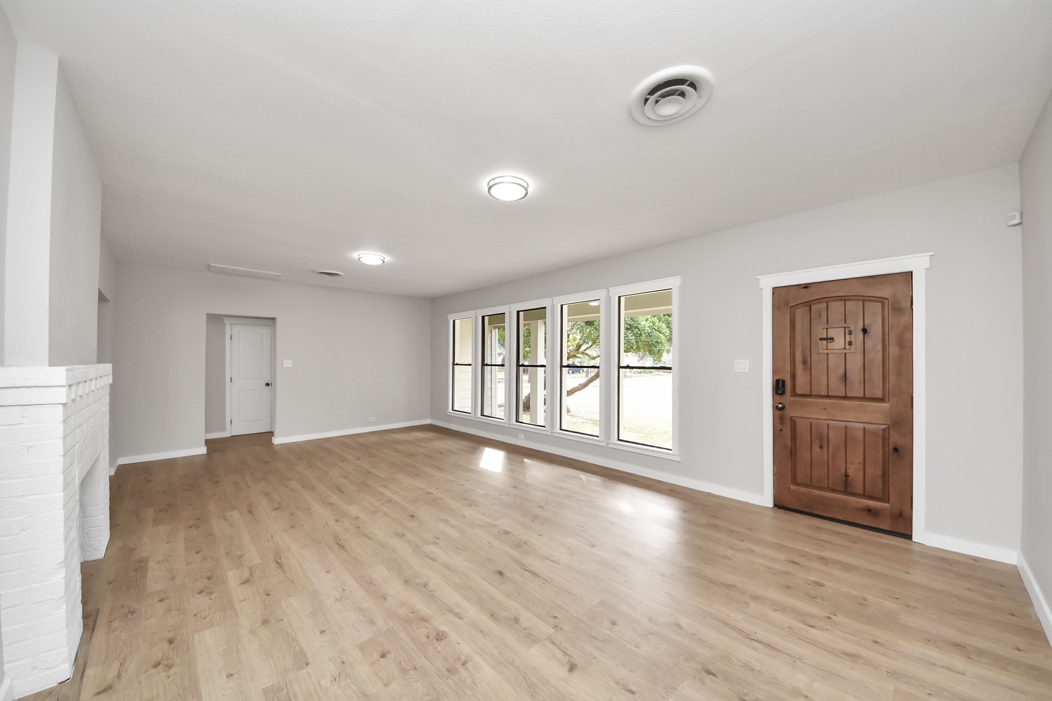 1507 Brooks Avenue Rosenberg, TX 77471 - Photo 5 of 35 a view of an empty room with a window and wooden floor
