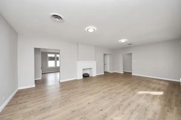 a kitchen with white cabinets stainless steel appliances and window