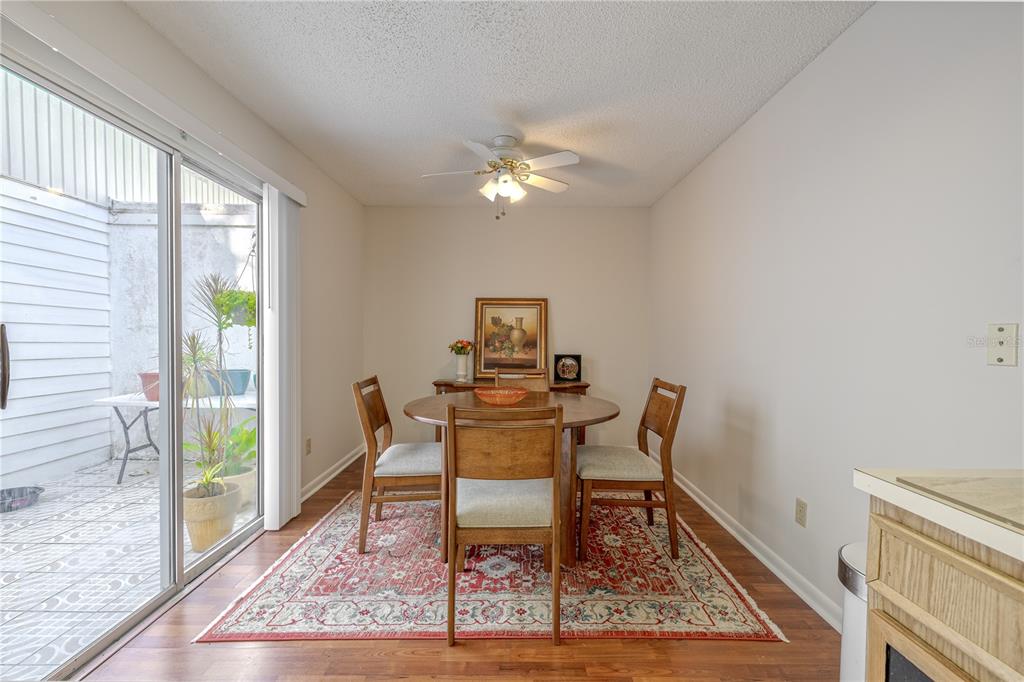 1131 Orange Tree Circle West, Unit C Palm Harbor, FL 34684 - Photo 11 of 28 a view of a dining room with furniture window and wooden floor