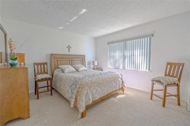 a bedroom with a bed chair and window