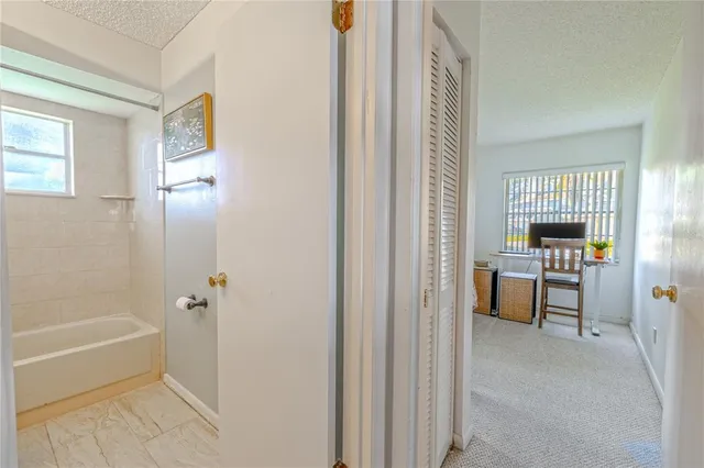 a bathroom with a tub and a view of bathroom