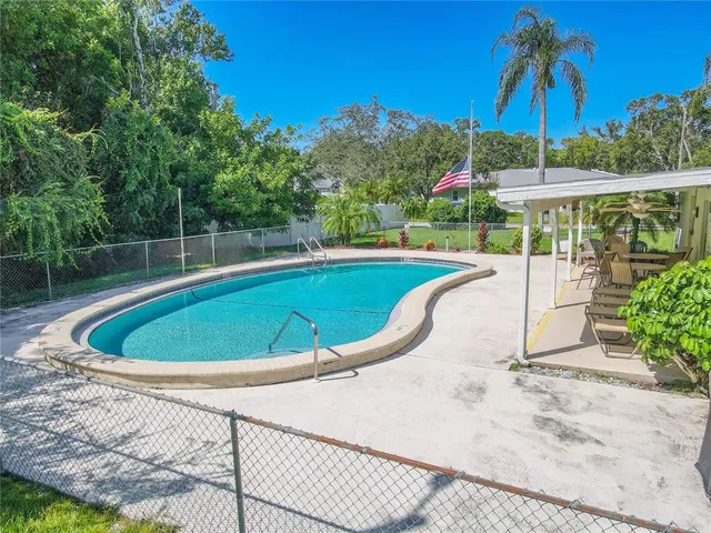 a view of a swimming pool with a patio