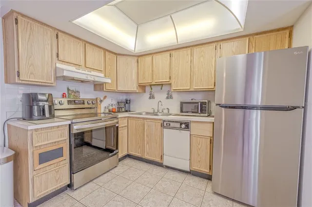 a kitchen with appliances cabinets and a sink