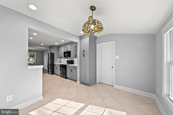 a view of a hallway with a kitchen