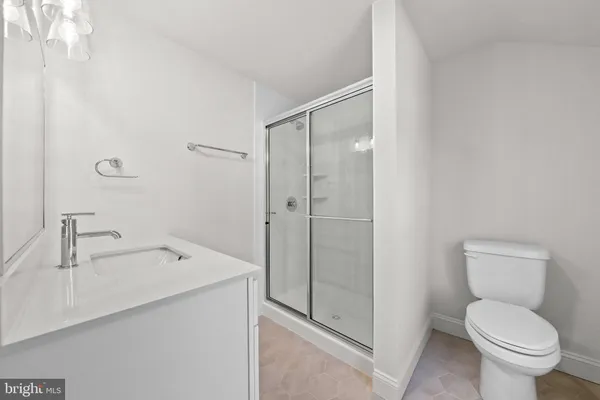 a bathroom with a toilet sink and shower