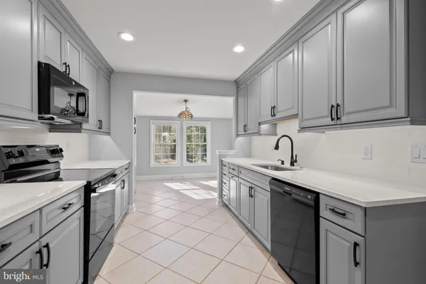 a kitchen with stainless steel appliances a sink stove and cabinets