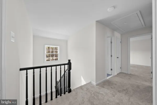 a view of a hallway with a window and stairs