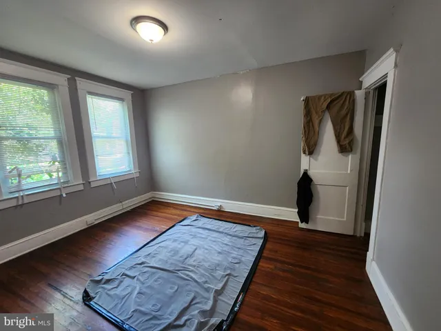 a view of a room with wooden floor and bathroom