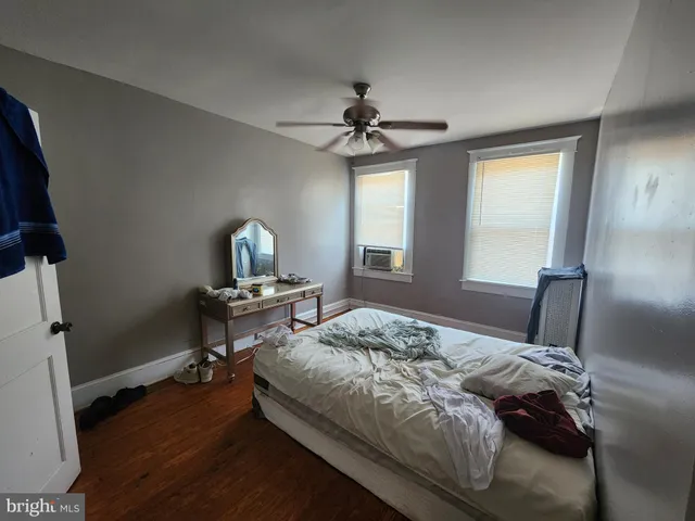 a bedroom with a bed dresser and a window
