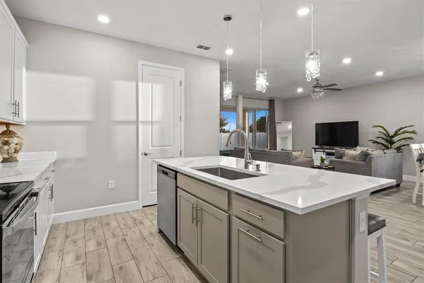 a kitchen with a sink a counter top space and appliances