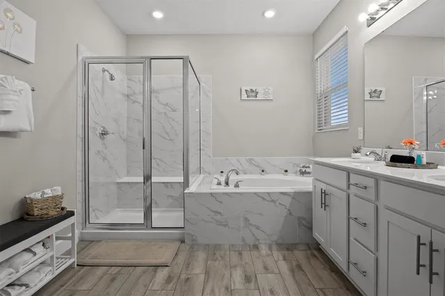 a bathroom with a double vanity sink mirror and shower
