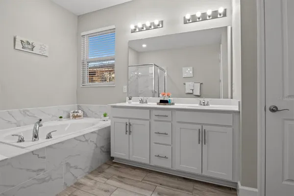 a bathroom with a double vanity sink mirror and