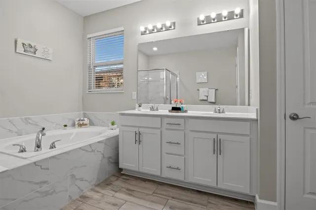 a bathroom with a double vanity sink mirror and