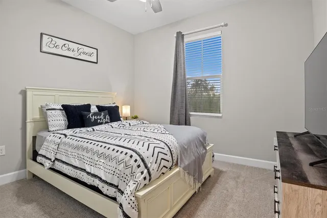 a bedroom with a bed and window