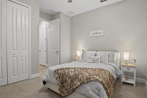 a bedroom with a bed and a night stand