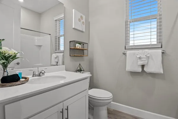 a bathroom with a sink toilet and vanity