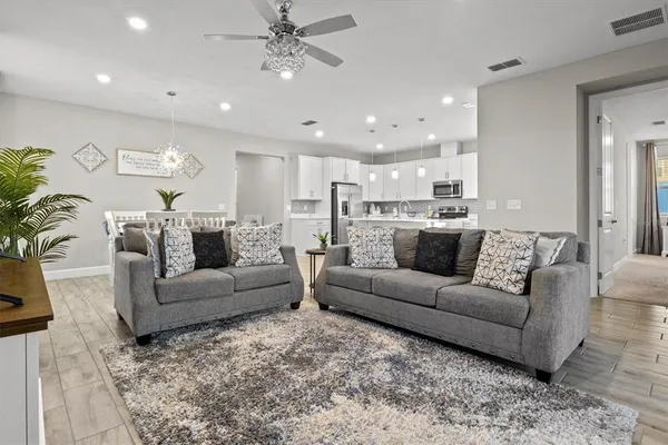 a view of a living room kitchen and a wooden floor