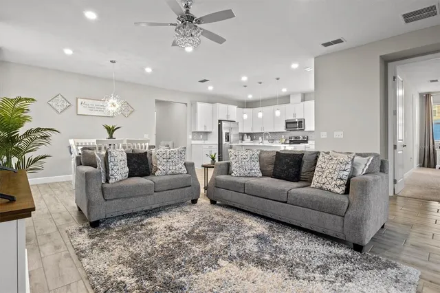 a view of a living room kitchen and a wooden floor