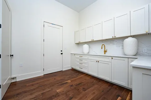 a kitchen with sink cabinets and wooden floor