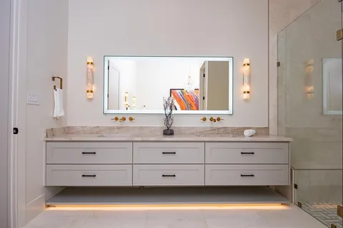 a bathroom with a double vanity sink and mirror