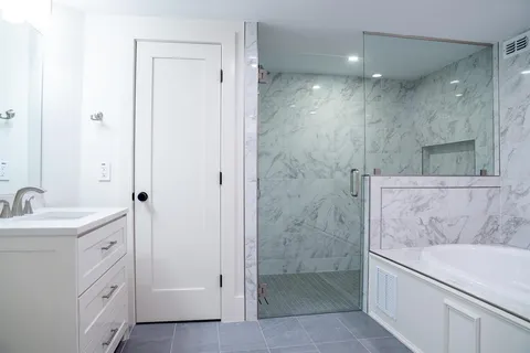 a bathroom with a sink a toilet and shower